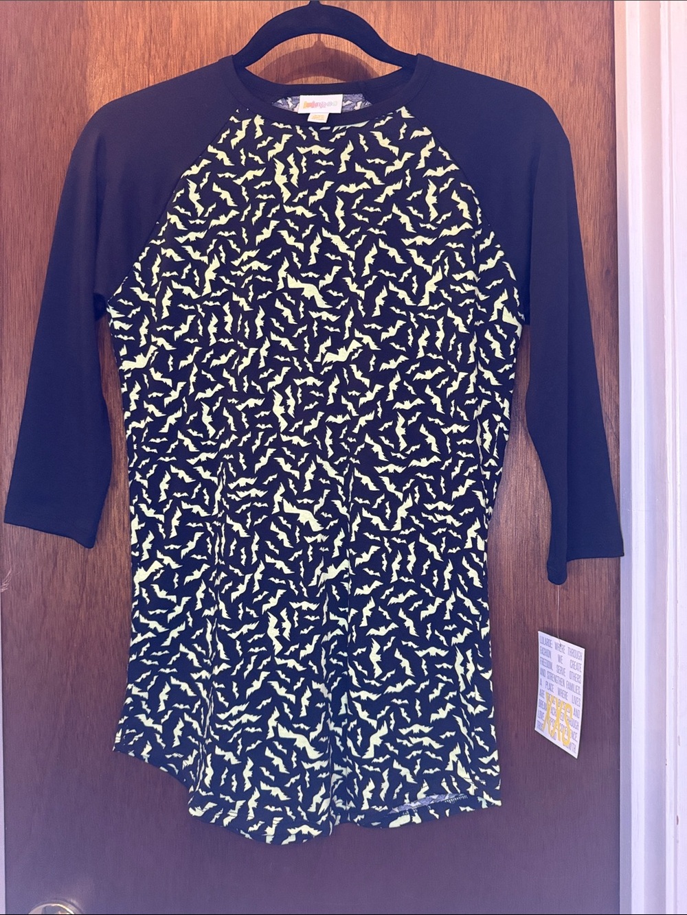 LuLaRoe Black Raglan Top with Yellow Bat Print
